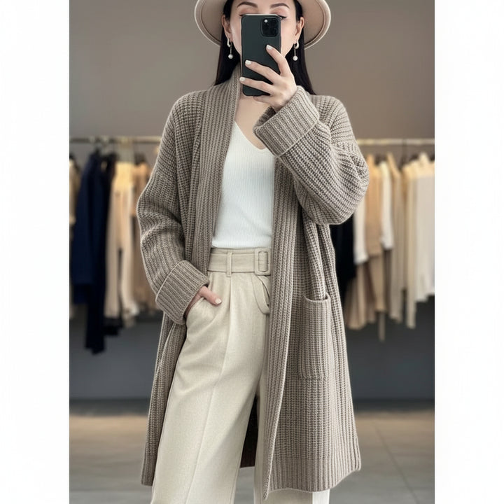 Person wearing a long, textured brown coat in a clothing store.